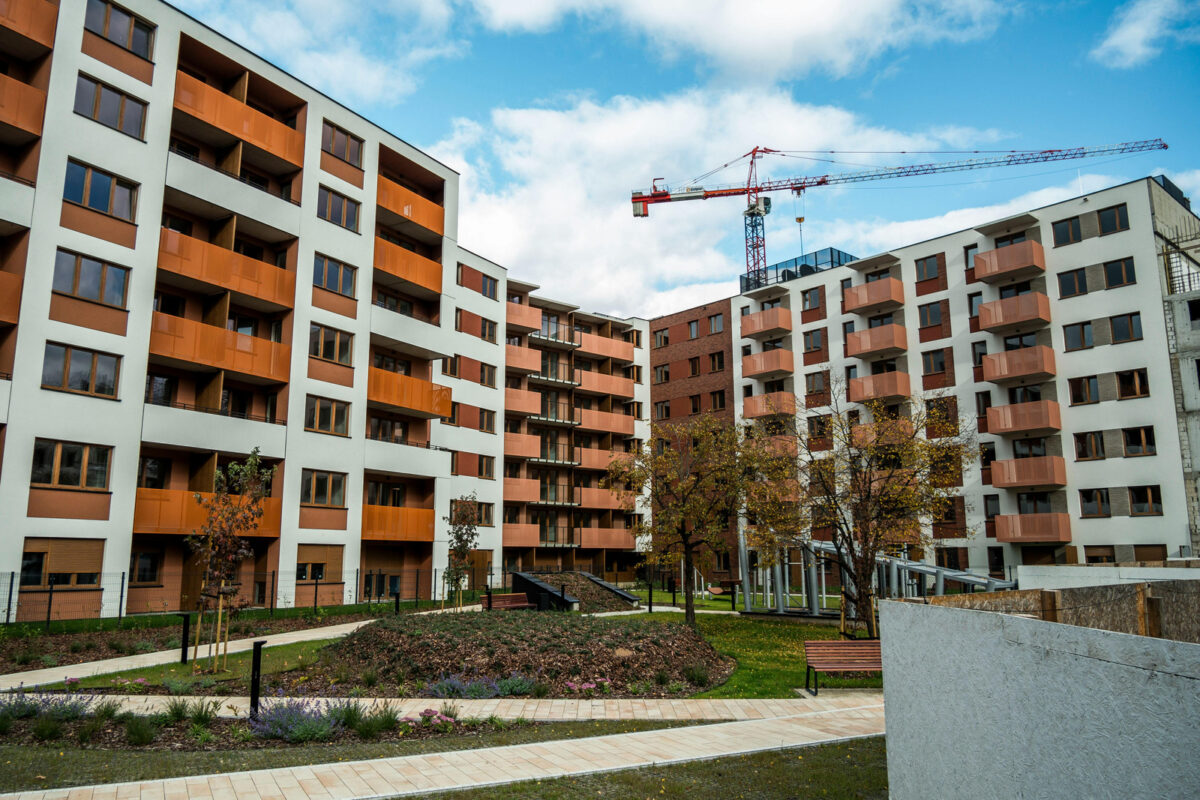 Modern apartment complex with construction crane